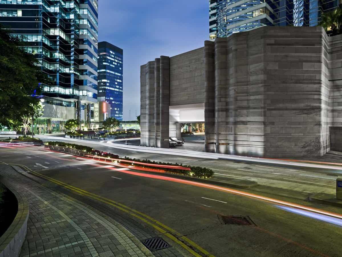 The road in front of the hotel, showing the car park, at dusk