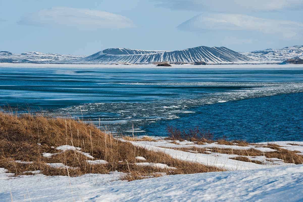 beautiful wintry landscape of Lake Myvatn with volcano cone in centre