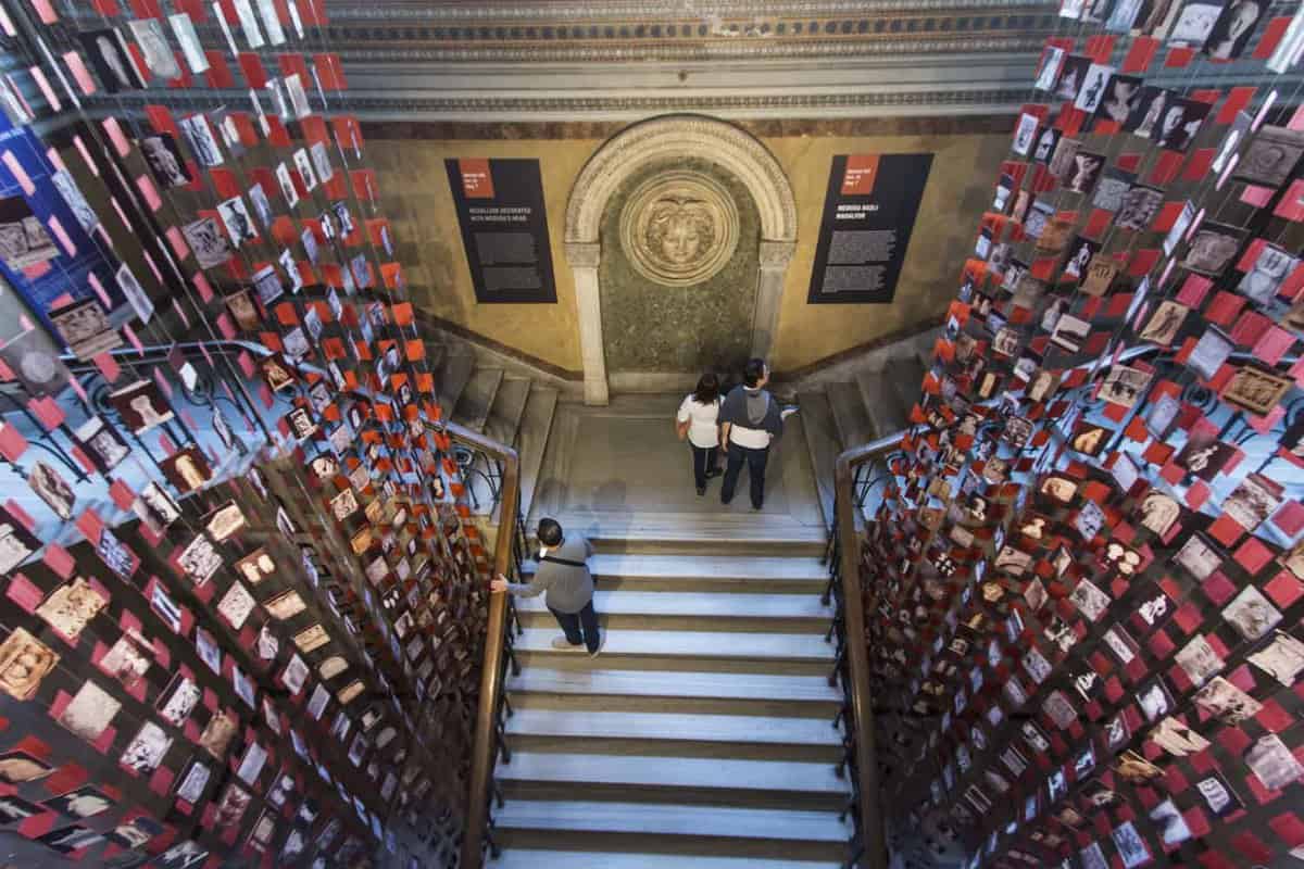 Interior staircase in museum with visitors walking up