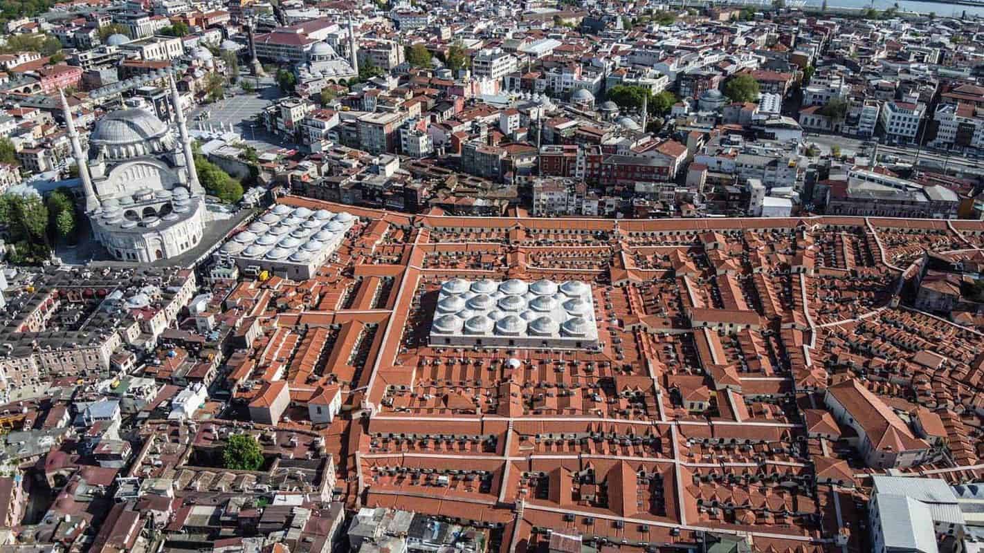 Aerial photograph of sprawling, ochre covered market complex and surrounding city