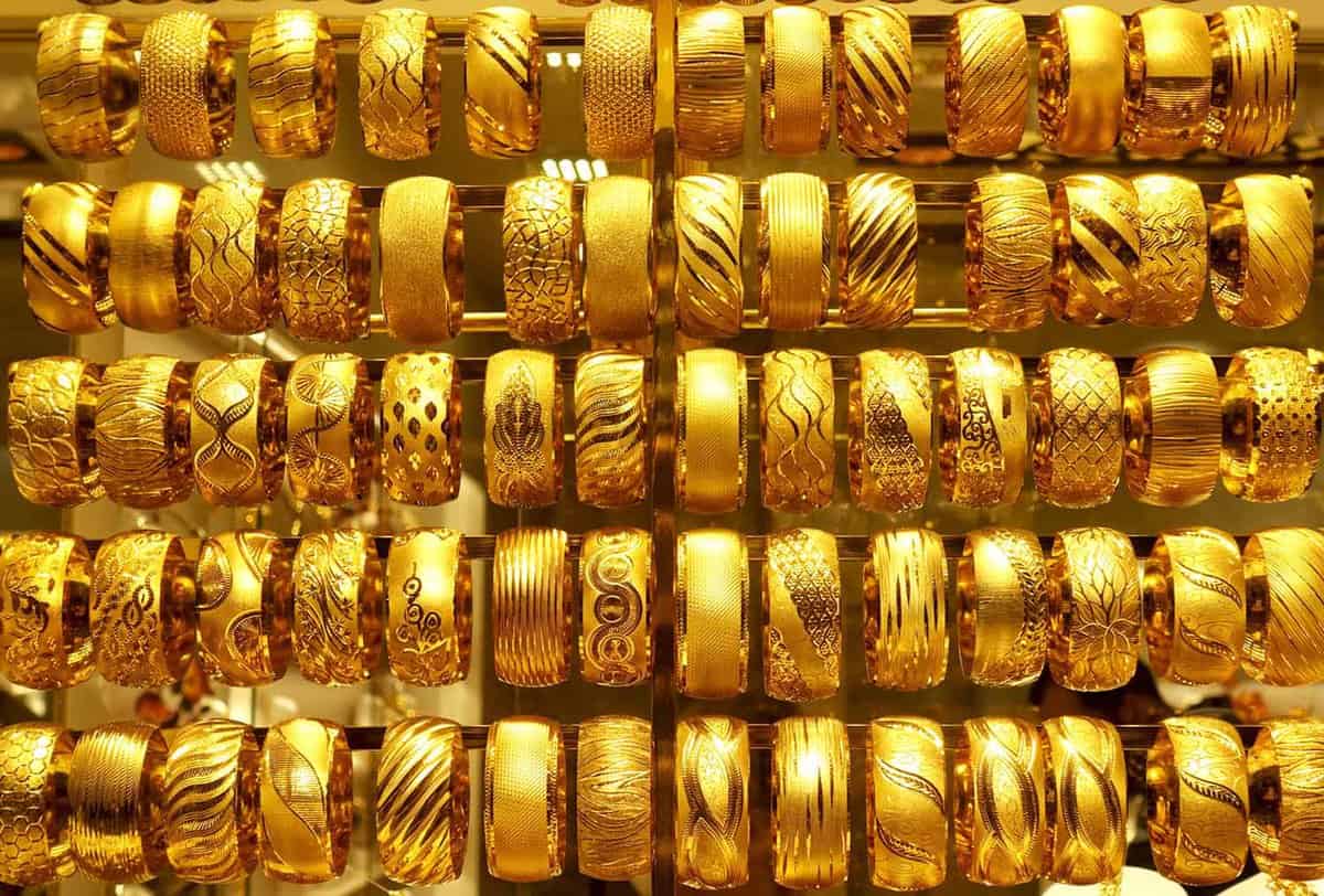 Close-up of patterned gold earrings on display in a shop