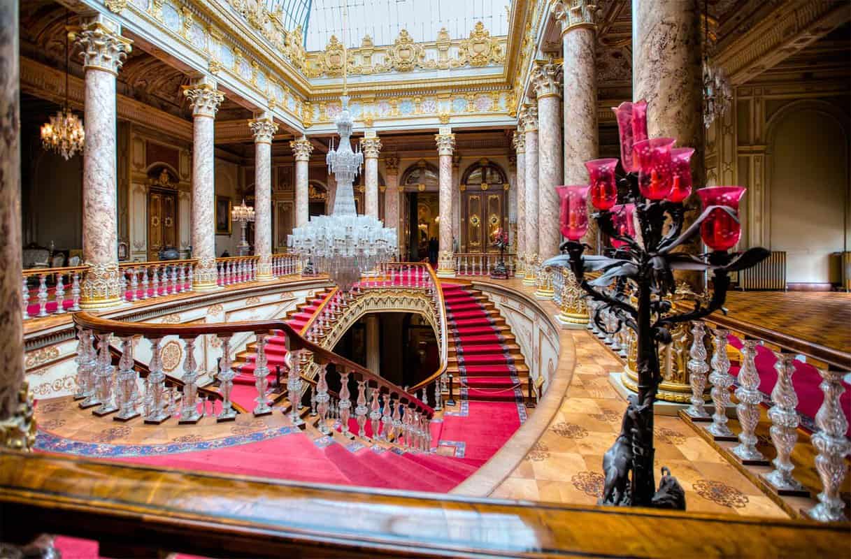 Opulent red-carpeted staircase in palace