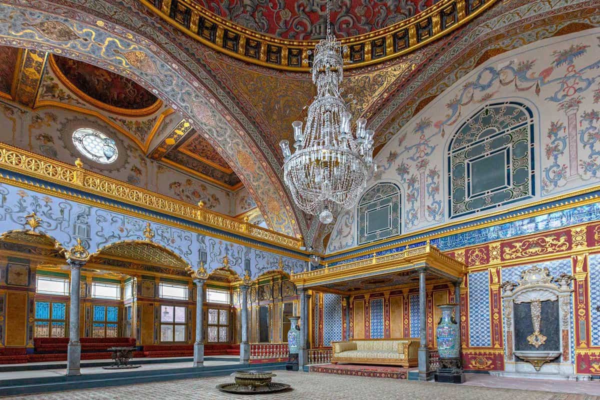 Domed, palace room with tiled walls and crystal chandelier
