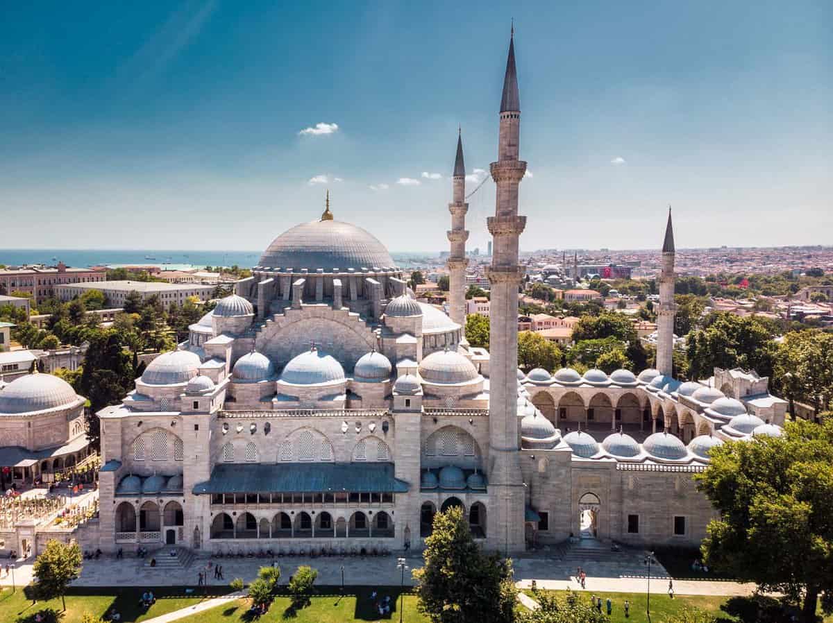 Aerial view of large, blue and white mosque on a sunny day