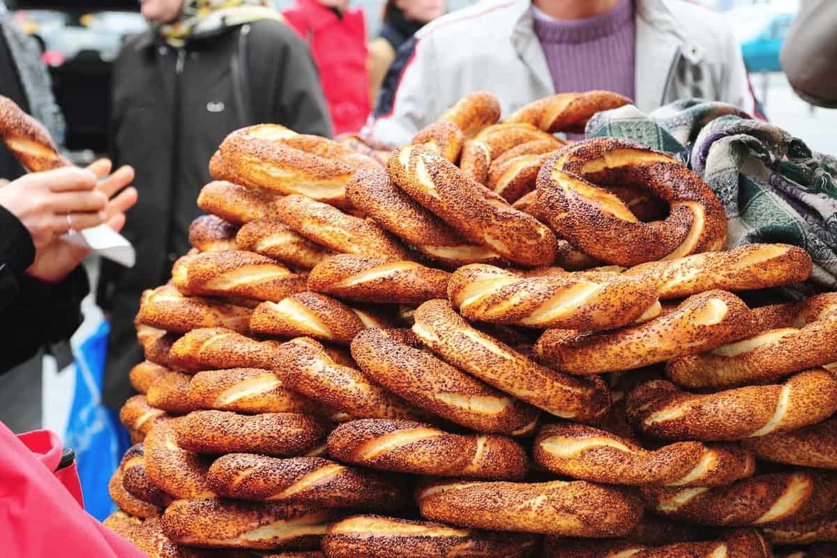 A pile of Turkish poppy seed-covered bagels (simit) at a street vendor