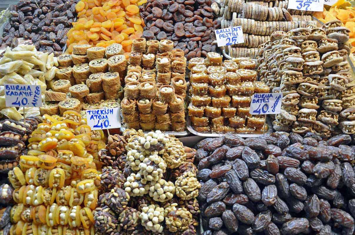 Close-up of baklava, Turkish delights and dried fruits stacked high in front of a vendors shop