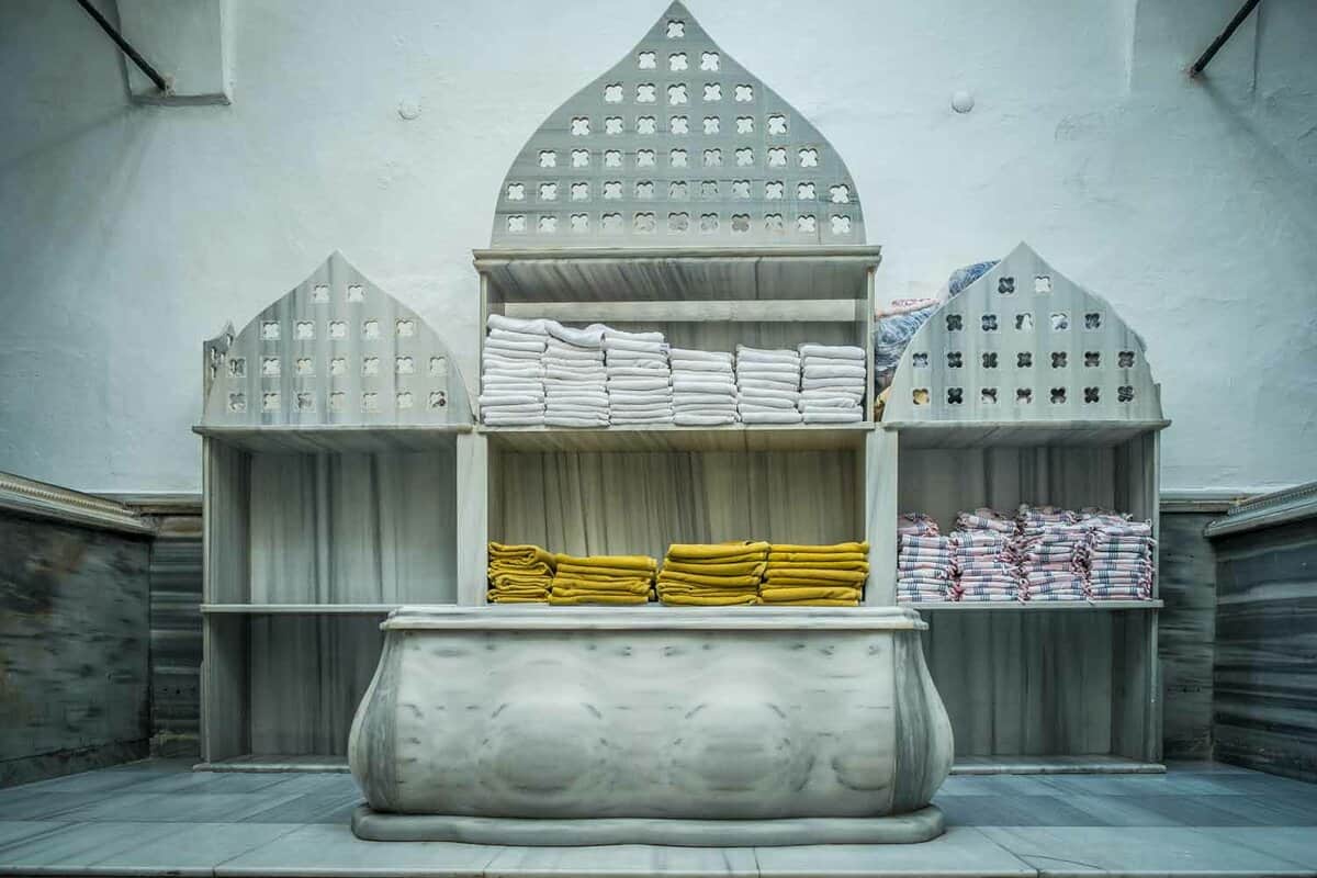 Towels stacked on an ornate, marble replica of a Turkish bathouse