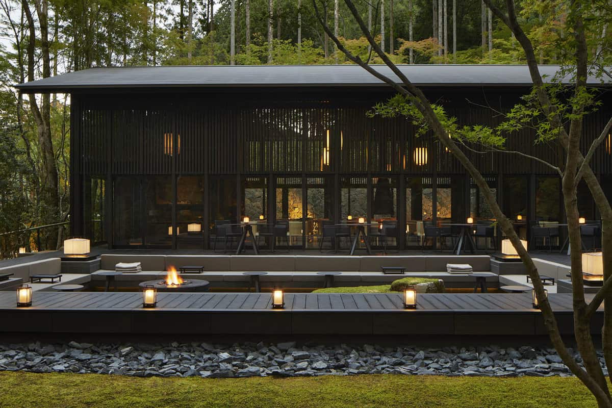 Cabin pavilion patio lit by lanterns at dusk