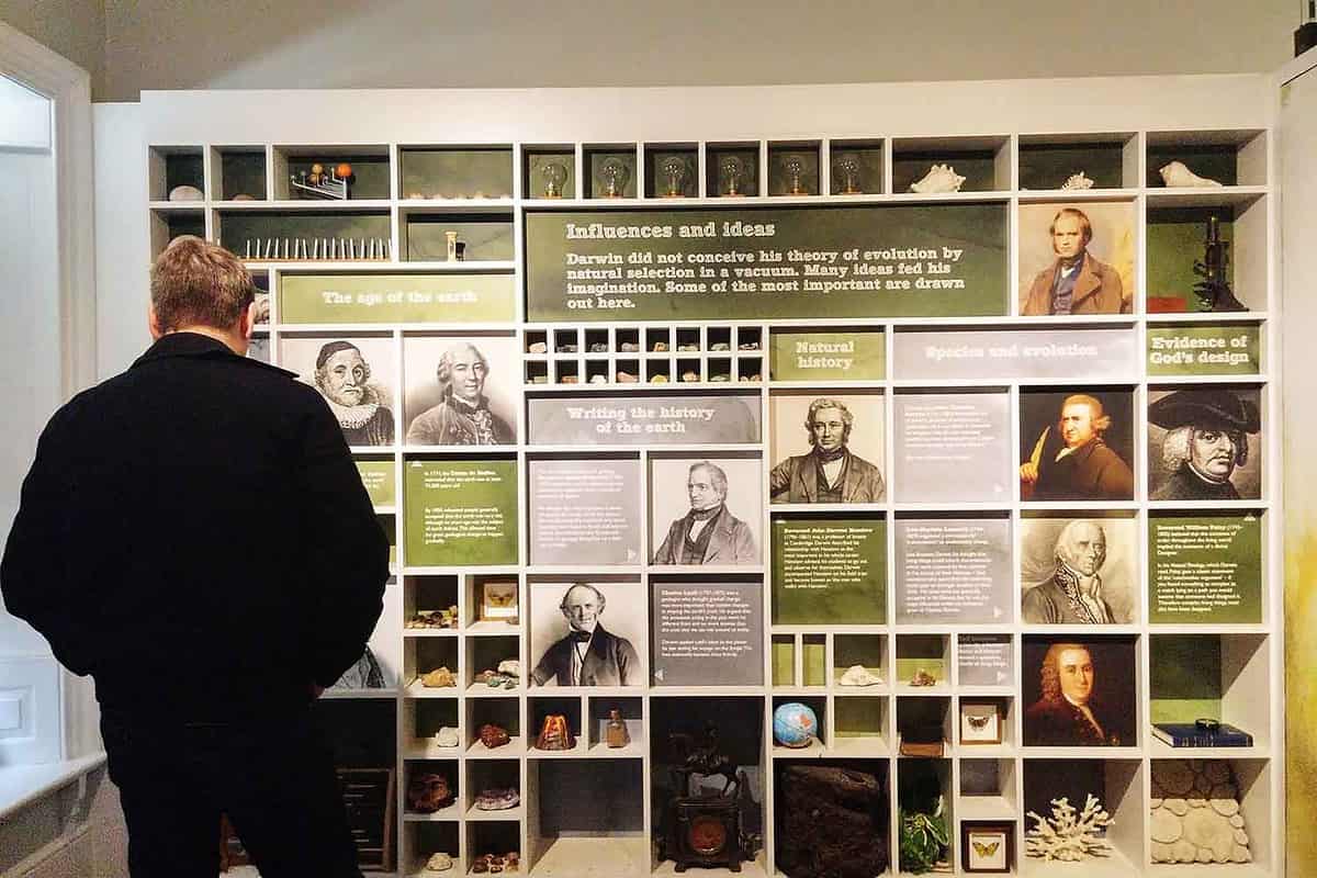 Undefined man looking on board of exhibition in the history of science, Down House, the home of Charles Darwin where Darwin wrote 'On the Origin of Species', Kent, UK