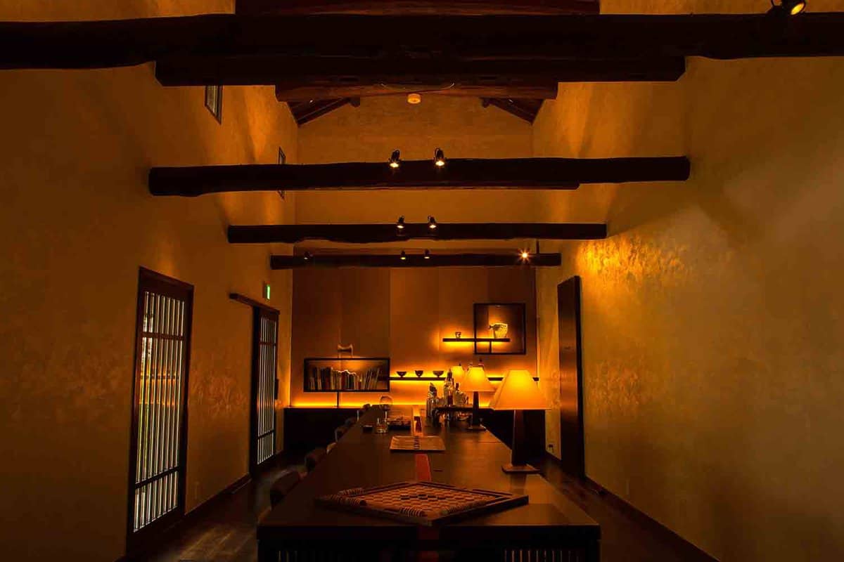 Warmly lit foyer with wood ceiling beams