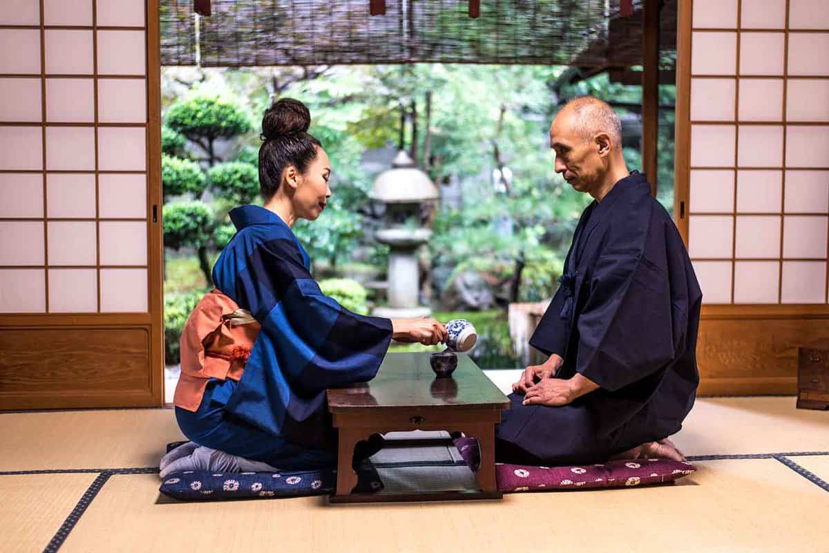 A man and woman sit down to traditional Japanese tea