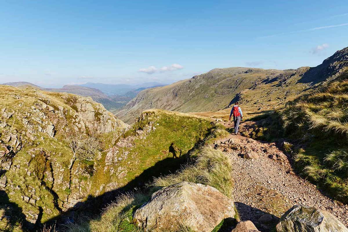 Person walking on a trail at the top of Scafell Pike