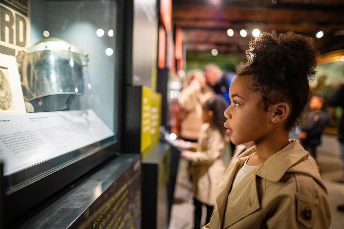 Young girl staring at display cabinet in the museum