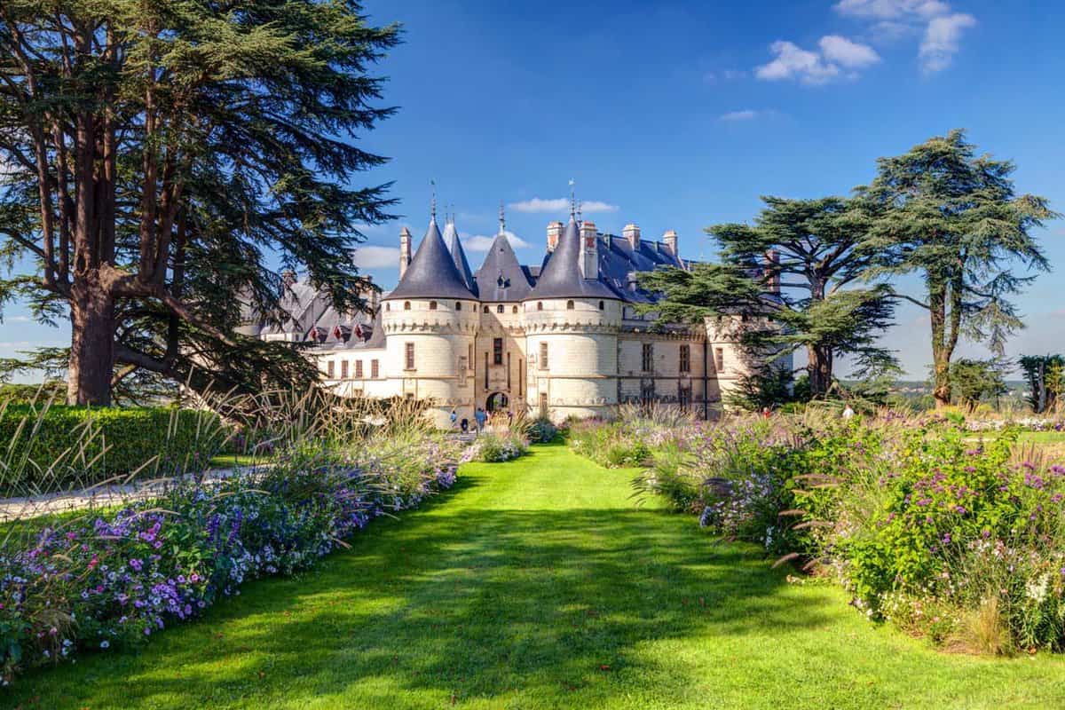 Chateau Chaumont, with a view of the grass and flowers along the walkway, in a beautiful garden