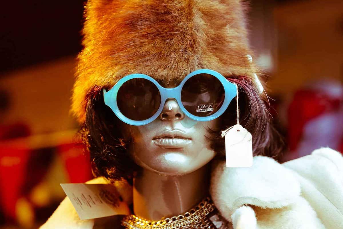 Close up of a mannequin wearing outrageous 70s clothing and blue glasses