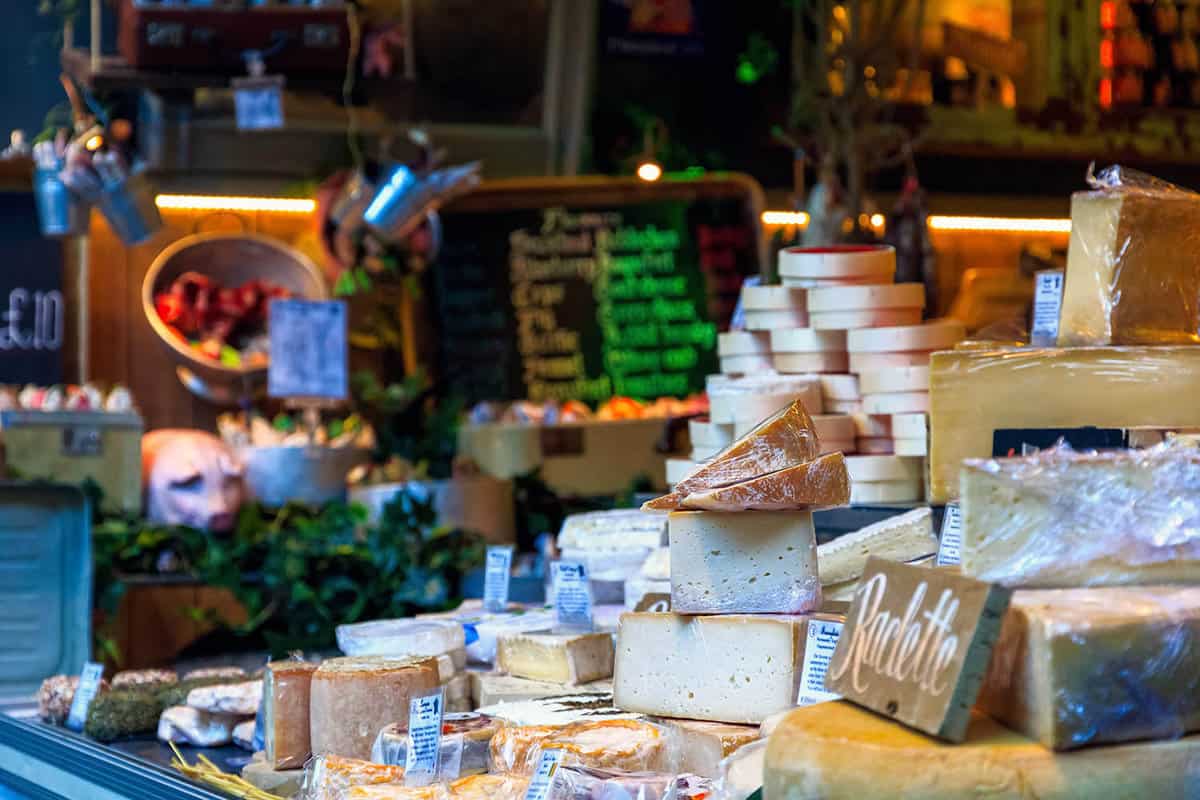 A collection of cheeses up for sale at the market