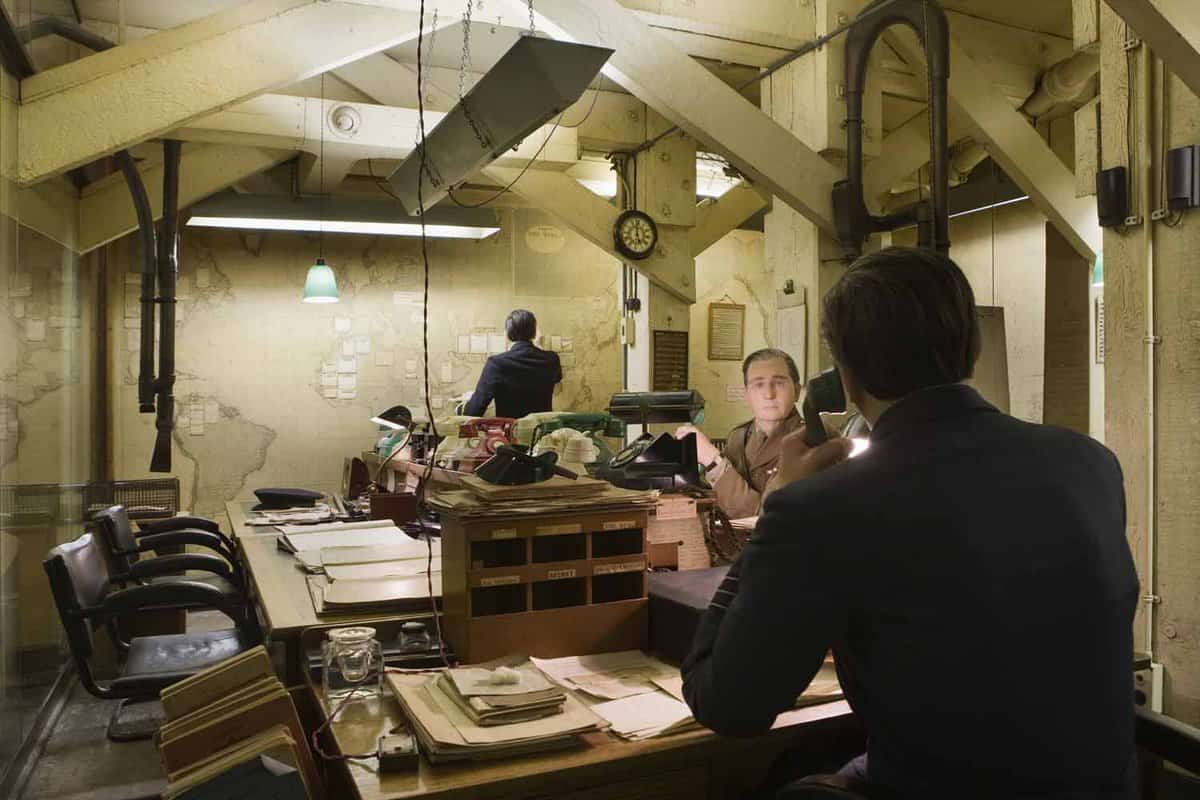 Room in the bunker showing a large map on the wall with flags/notes on