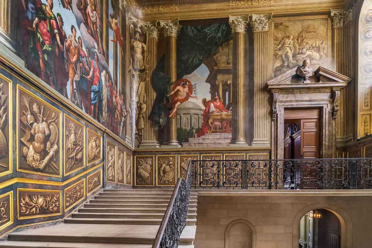 A staircase with large paintings printed on the side of the wall