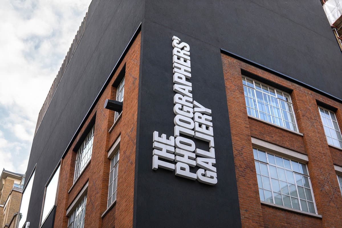 Close up of the external signage on the side of the black and red brick building