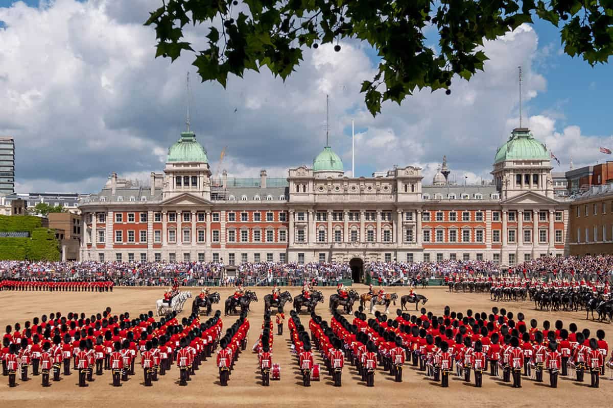 View of the parade ground filled with soldiers all lined up and crowds watching from stands