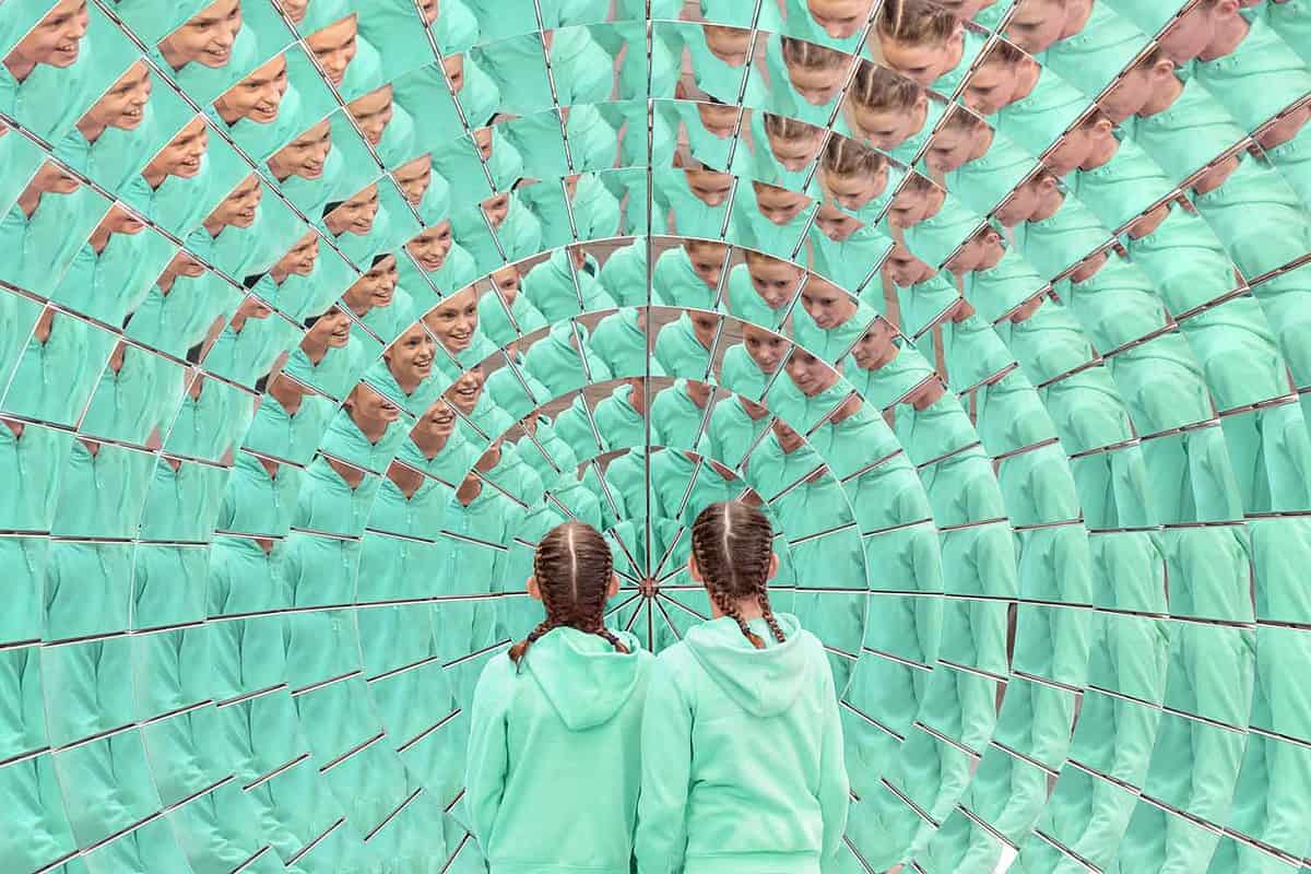 two girls in front of mirror illusions in the London Science Museum