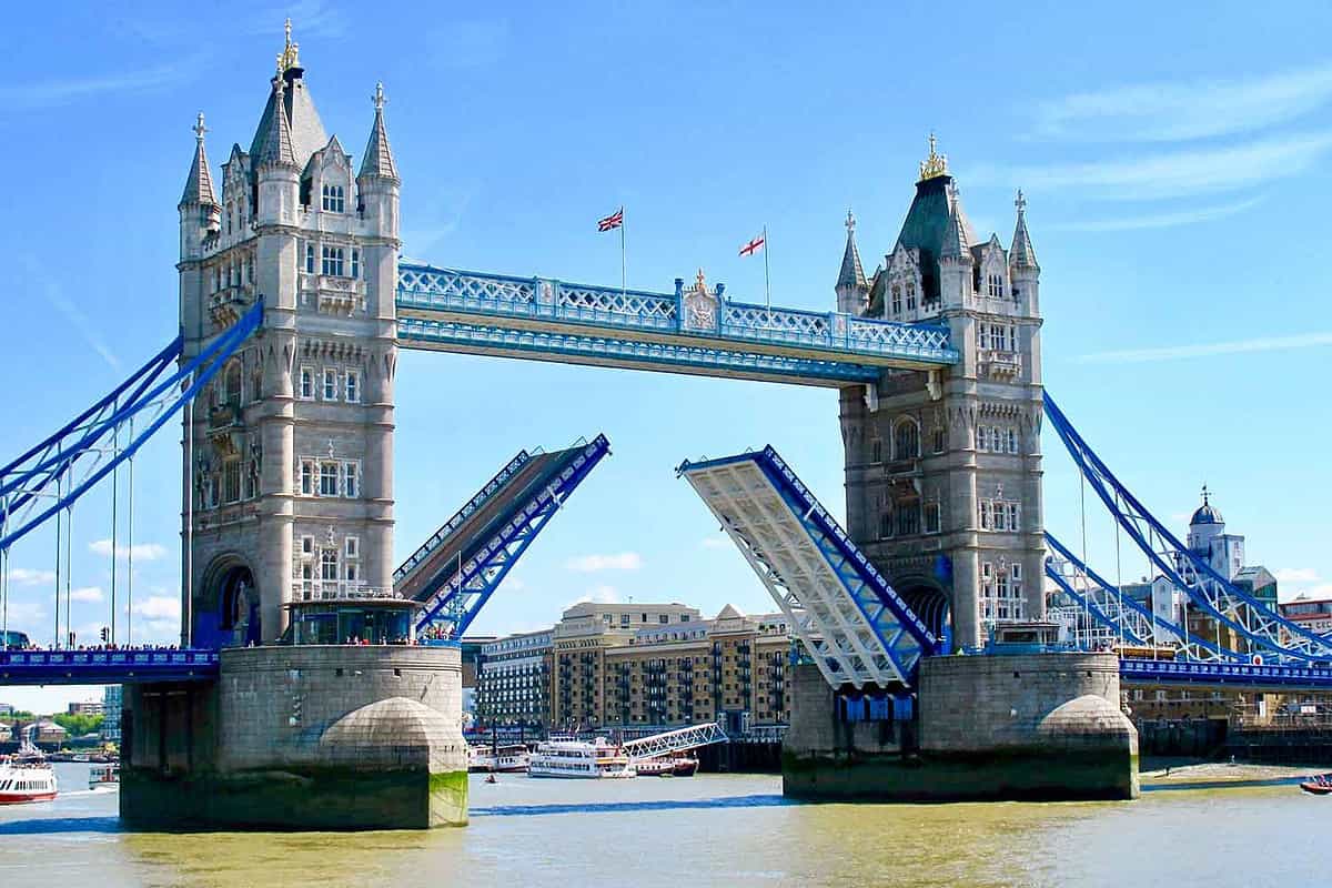 Tower Bridge's famous gate opens on River Thames during summer. London, England.