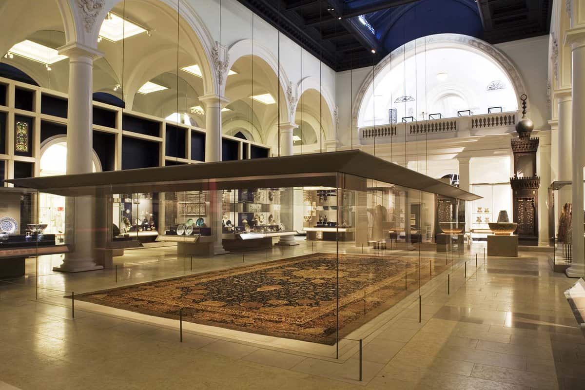 Interior gallery showing a large carpet set in a display case