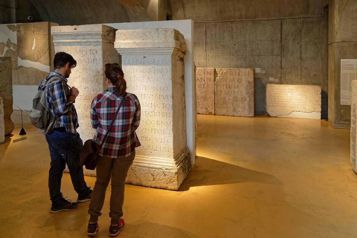 Young couple inside the museum staring at some building stone columns