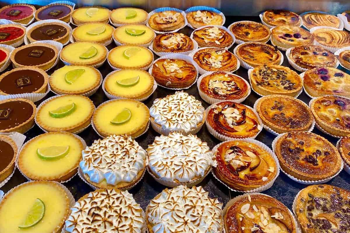 Close up of rows of cakes in a patisserie