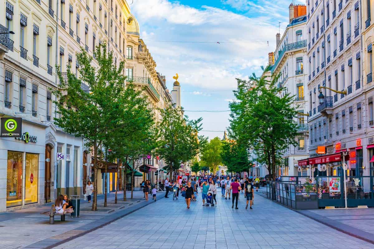 People are strolling through rue de la republique in the historical center of Lyon, France