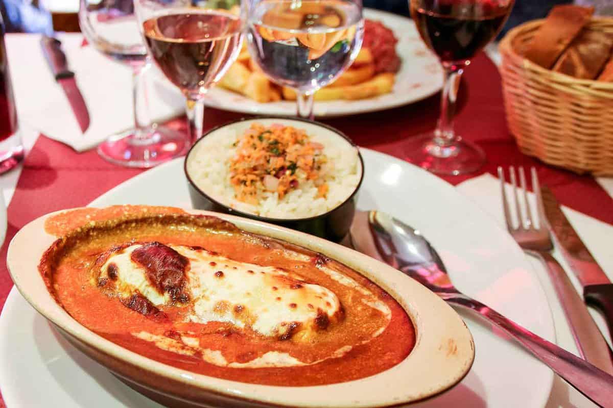 Close up of a dish containing cheese covered filling