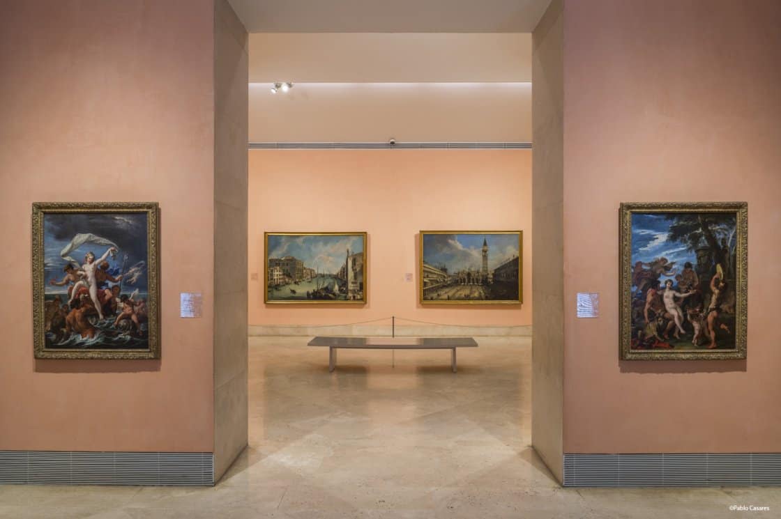 paintings hung on the peach walls of the museum.