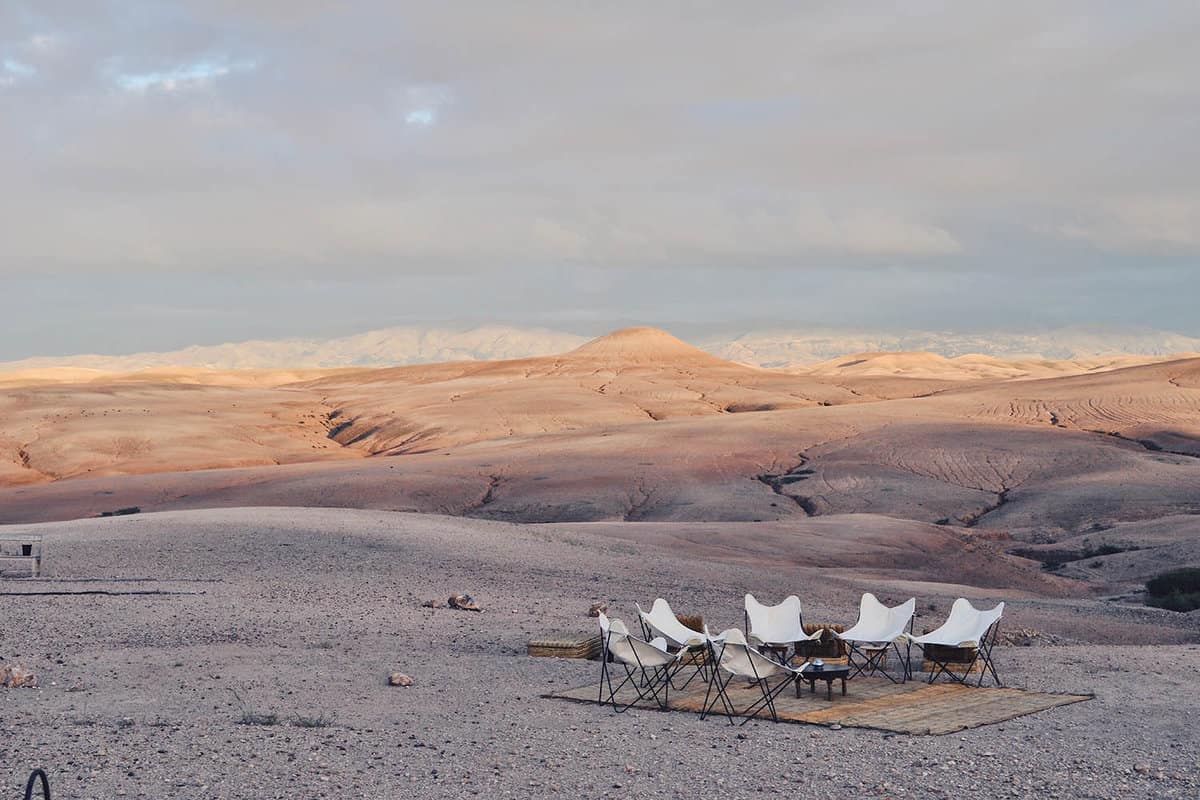 Chairs around a campfire in the desert
