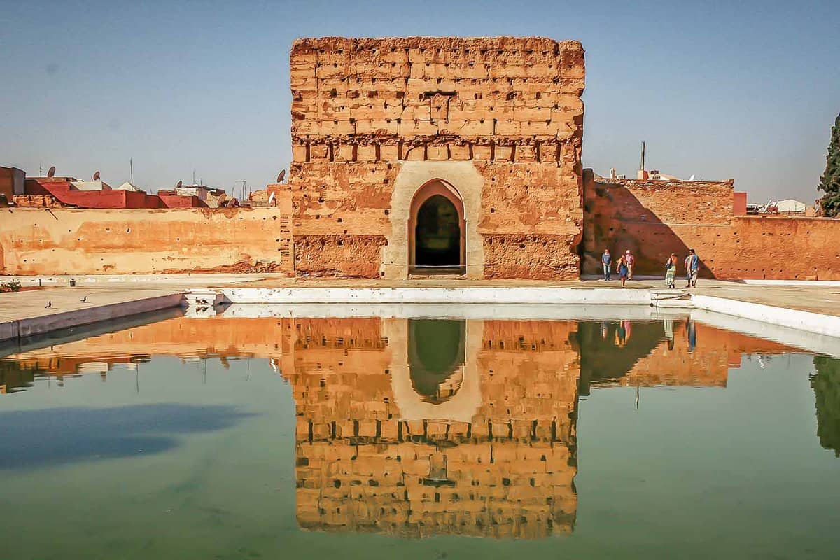 Old stone palace with reflective pool of water in front