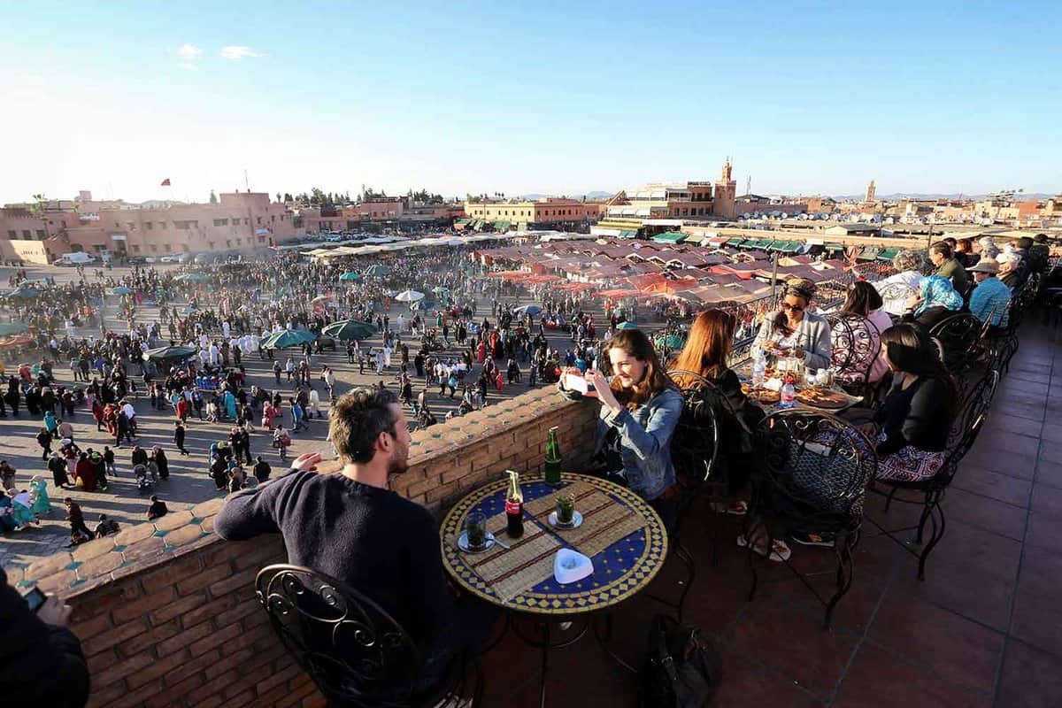 A couple having tea on a balcony cafe overlooking the square