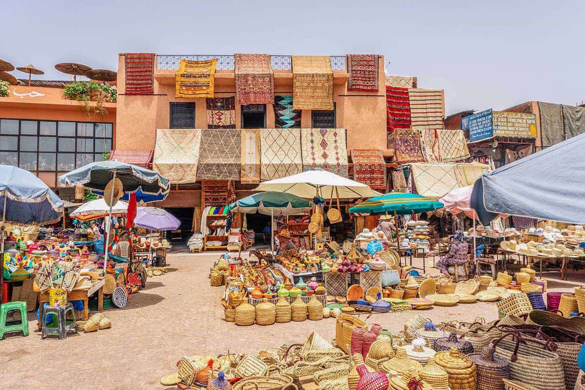 Market stall selling carpets, souvenirs, spices and baskets on a sunny day