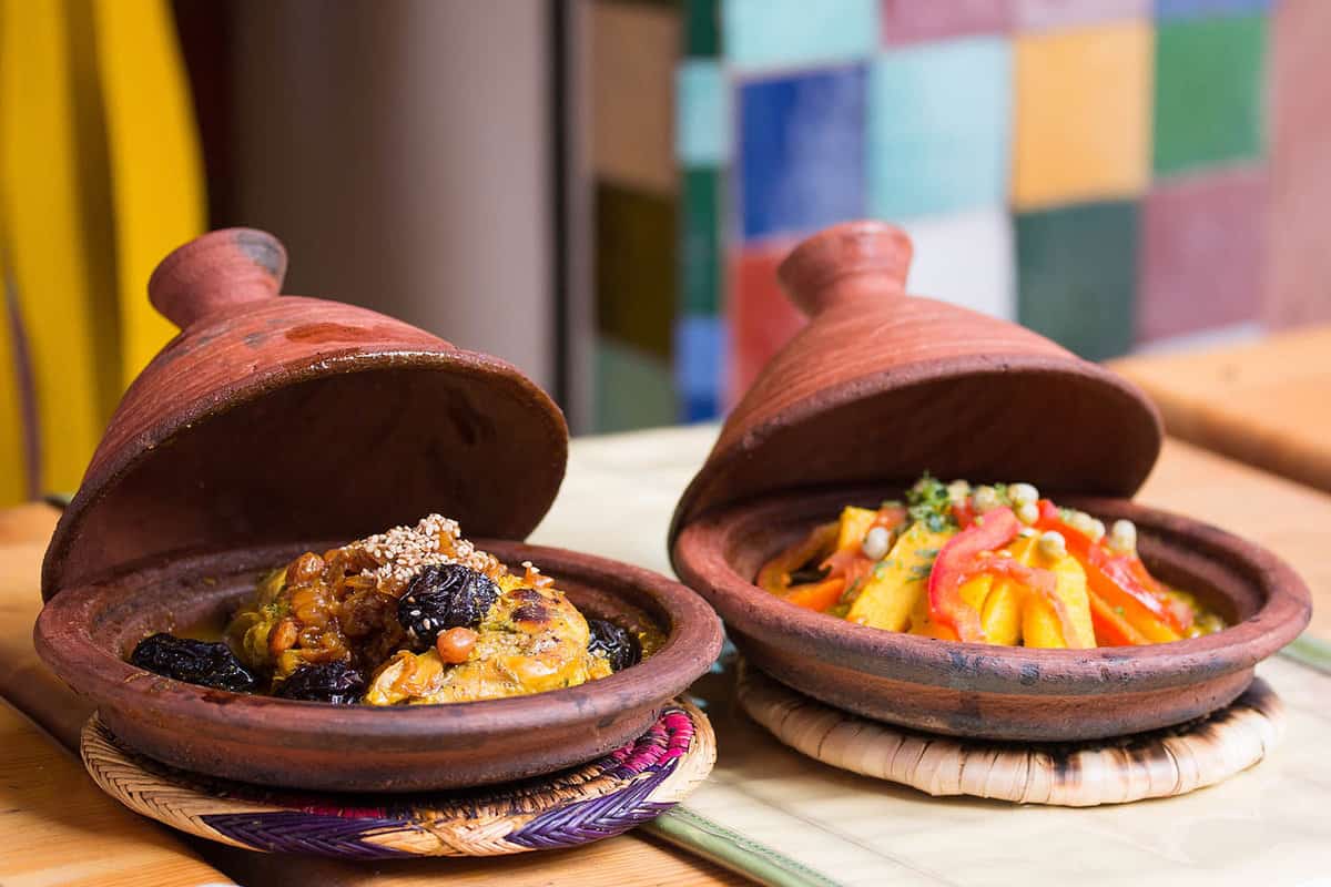 Two Moroccan tajines full of meat and vegetables