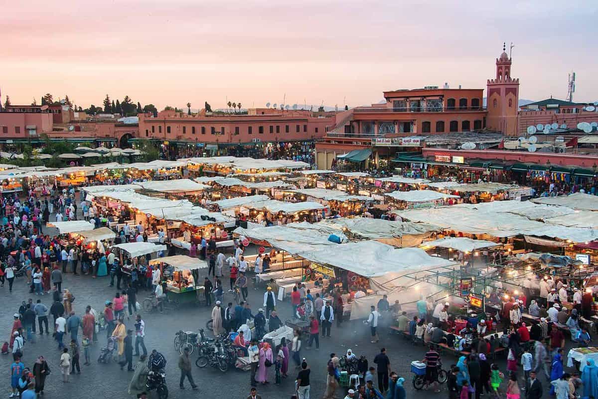 aerial view of the square at dusk, with lots of people walking around stalls