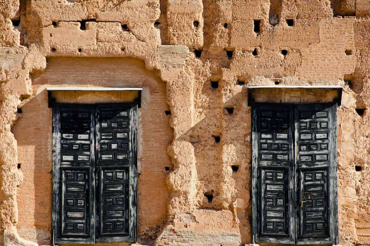 Old, wooden doors embedded in clay building