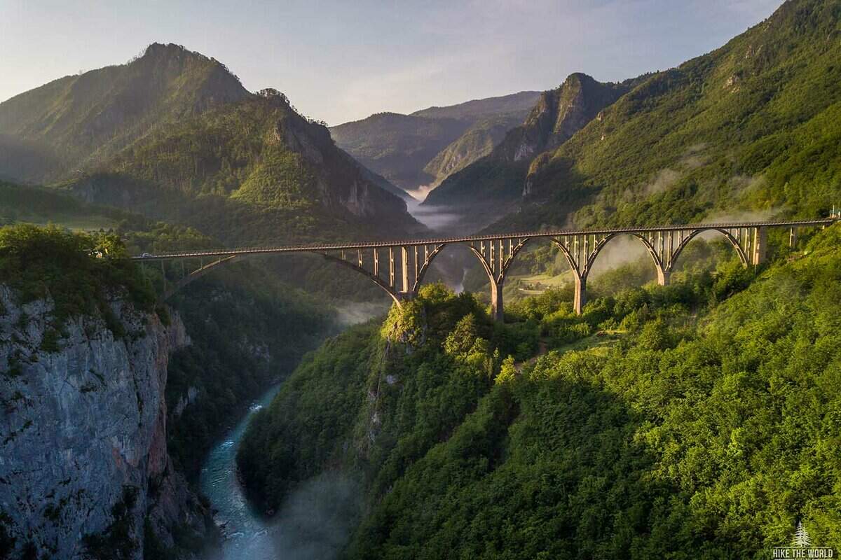 A stunning view of view of the Djurdjevica Bridge over the river Tara River Canyon on a beautiful misty morning