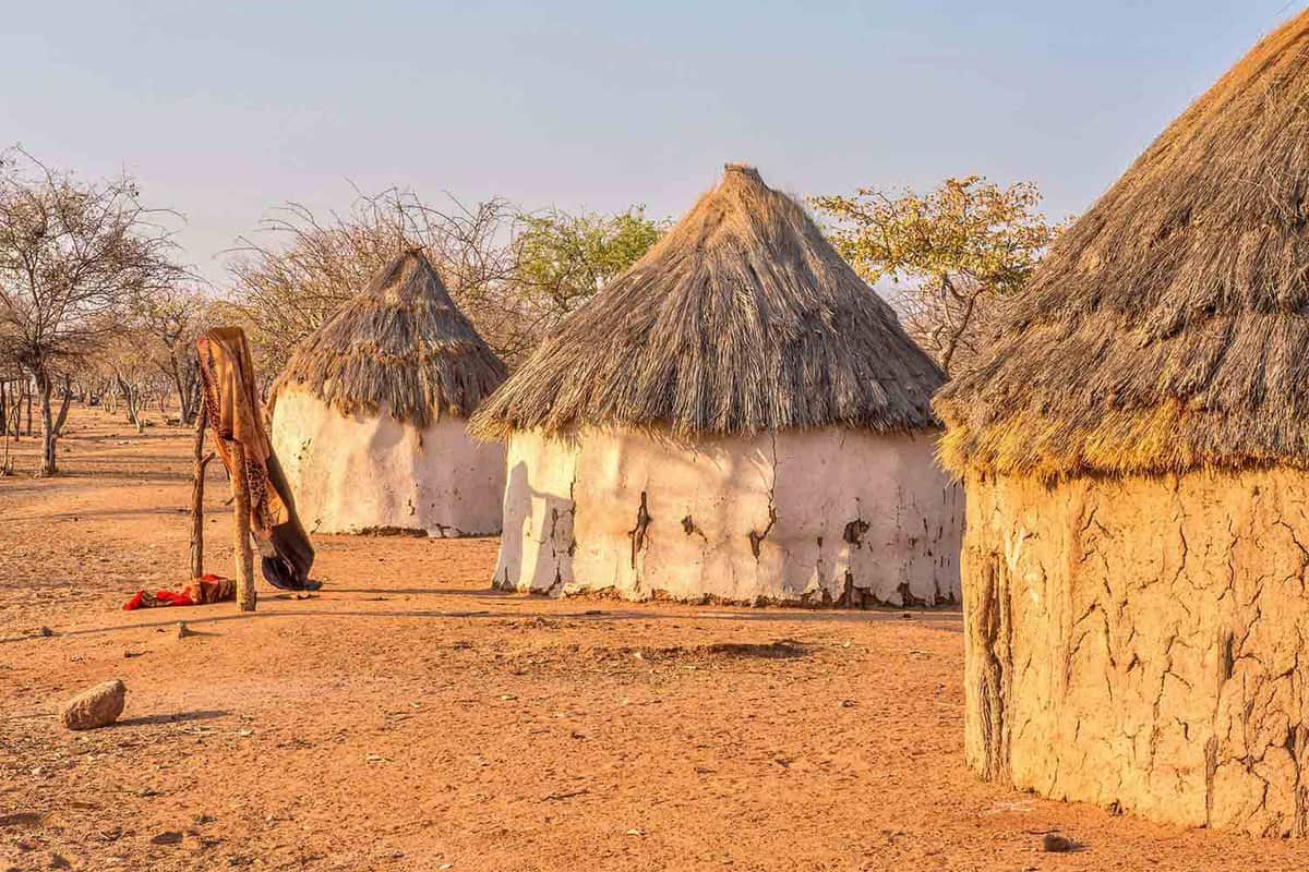 three traditional round thatched hima huts