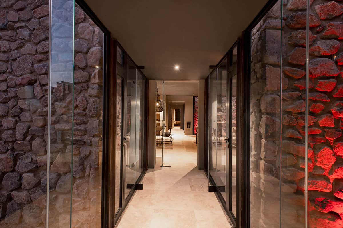 the corridor with stone walls and glass