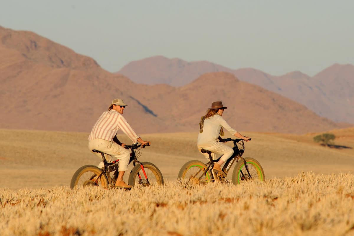 a couple on bikes cycling through the desert