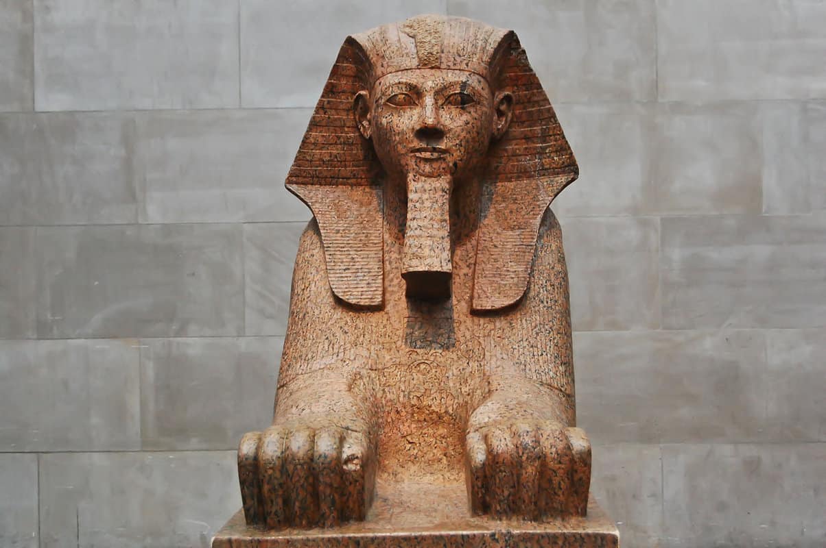 close up of an Egyptian sphinx on display in a gallery inside the Metropolitan Museum of art