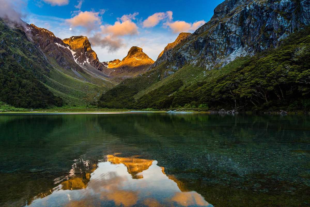 Emily peak reflecting in McKenzie lake at sunset, Routeburn track, South Island, New Zealand