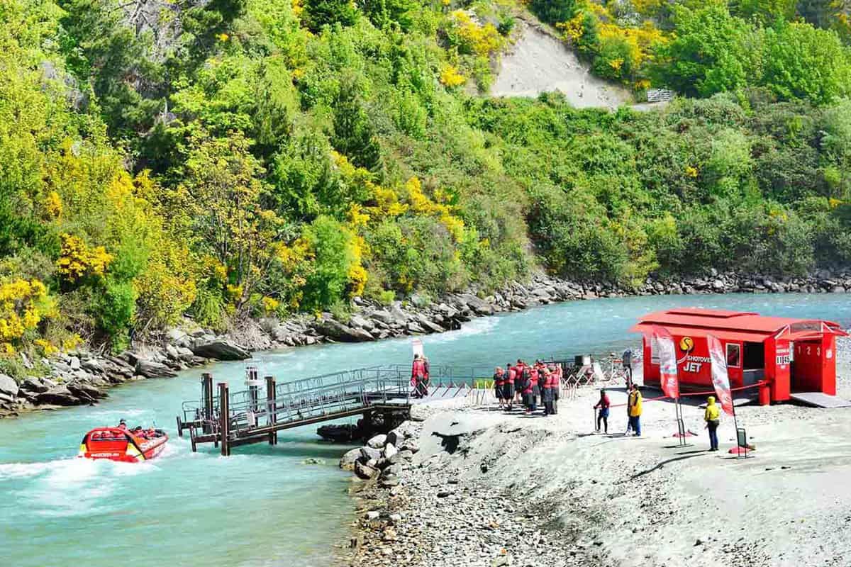 Tourists gathering at the departure point for the jetboat thrill ride