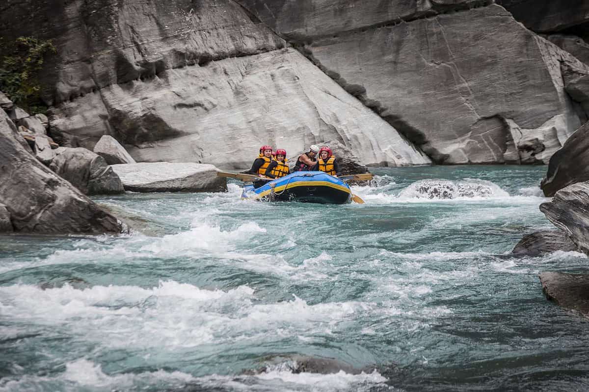 Inflatable raft on a fairly flat whitewater river in Queenstown