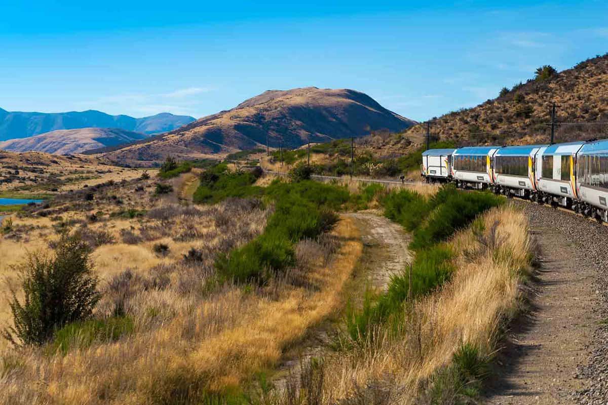 Arthur's Pass National Park, New Zealand, March 2019. KiwiRail TranzAlpine scenic train, riding among beautiful plains and mountains, popular tourist transportation on South Island