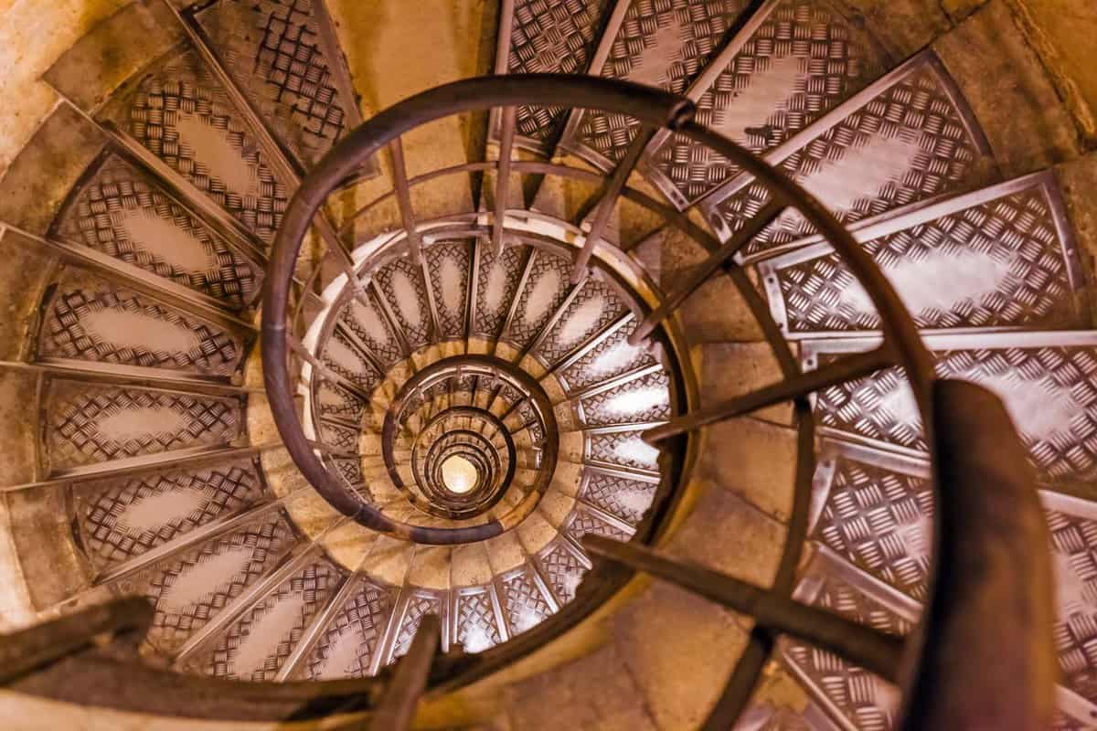 A Spiral stairs inside Arc de Triomphe with old single metal railings