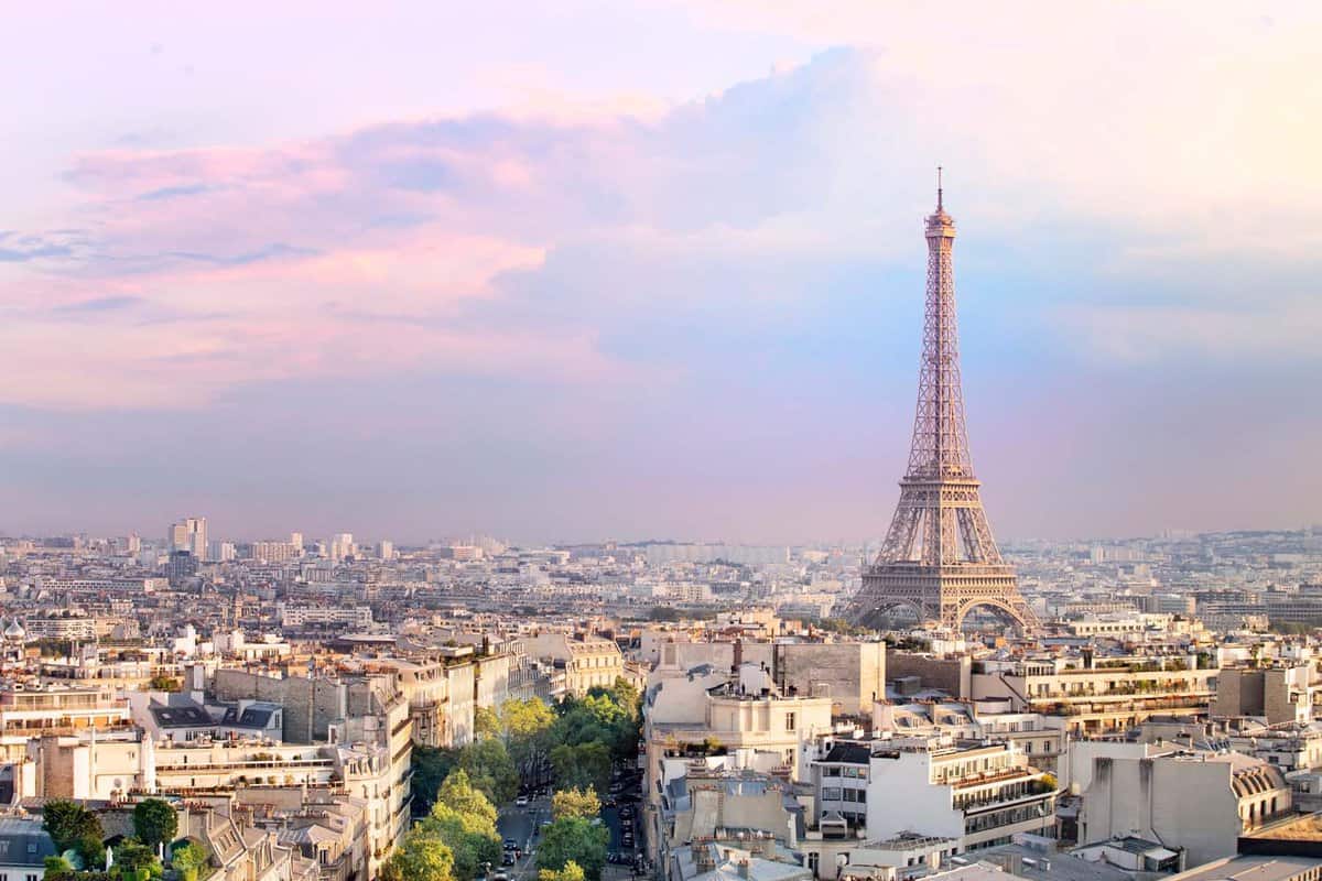 Landscape shot from Triumph Arc of the Eiffel Tower during a sunset amongst a pink and purple sunset